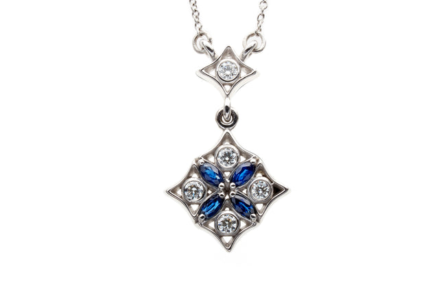 Night falls over graceful parterres. Diamonds glisten like dew forming on moonlit leaves and deep blue marquise sapphires articulate the gentle curves of geometric design. 