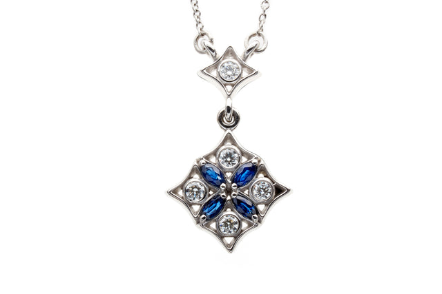 Night falls over graceful parterres. Diamonds glisten like dew forming on moonlit leaves and deep blue marquise sapphires articulate the gentle curves of geometric design.
