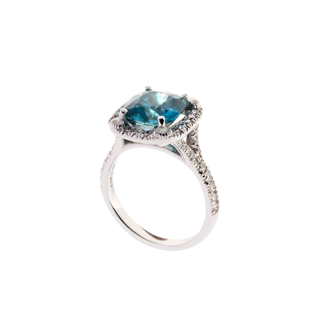 Blue zircon halo ring surrounded by round brilliant diamonds. Designed by Biagio Patalano