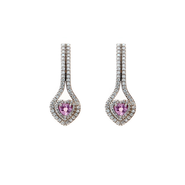 A pair of pink ruby sapphire heart earrings set in white gold, surrounded by round brilliant diamonds. Designed by Biagio Patalano. 