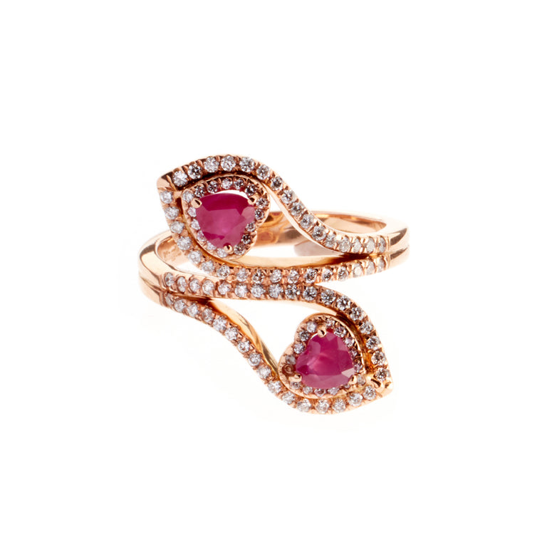 A pair of ruby hearts set in rose gold, surrounded by round brilliant diamonds. Designed by Biagio Patalano. 