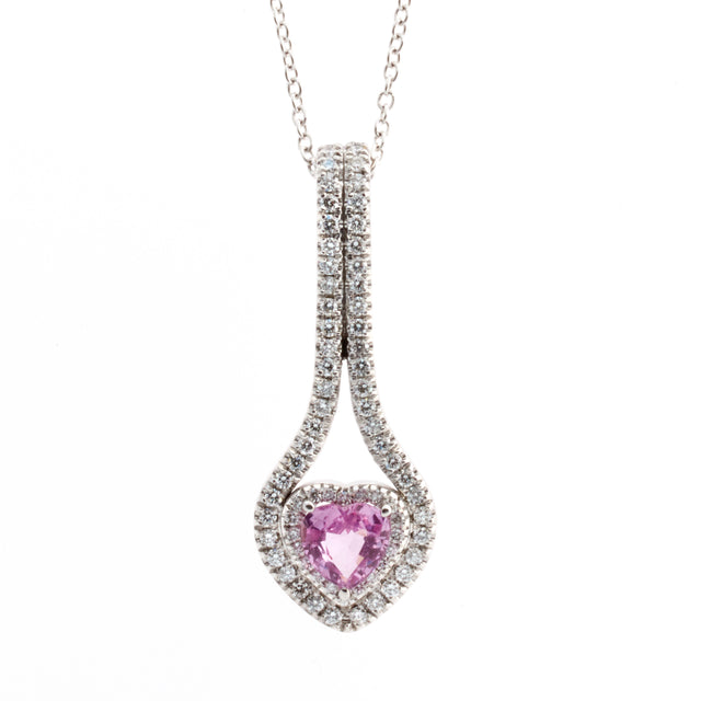 A pink ruby sapphire heart set in white gold, surrounded by round brilliant diamonds. Designed by Biagio Patalano. 