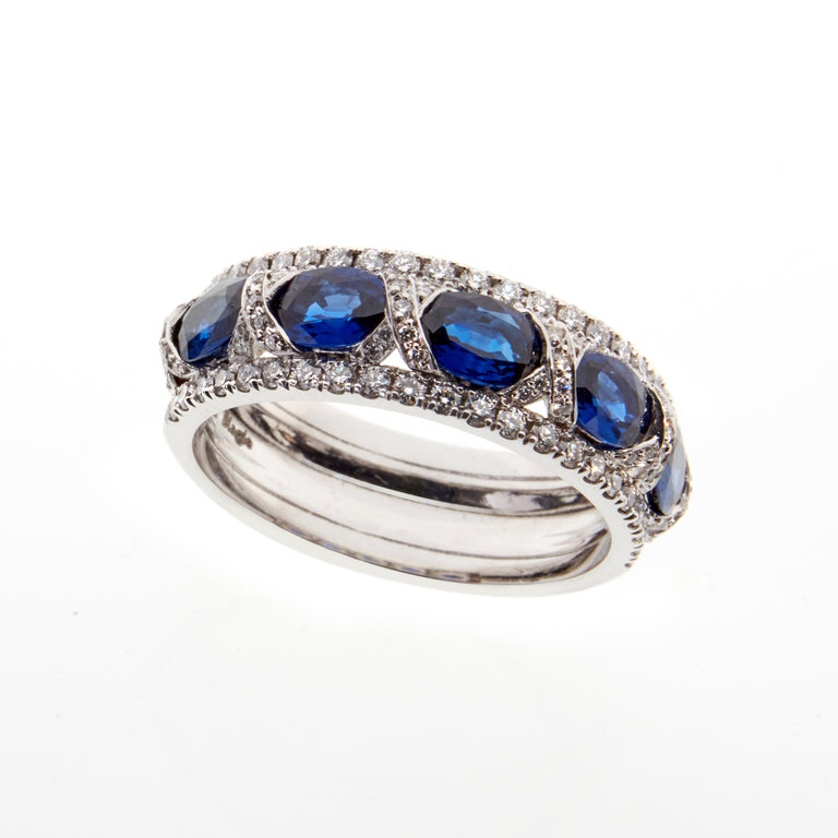 18ct white gold ring. Set with five oval blue sapphires and 0.52ct of pave set diamonds along each edge.