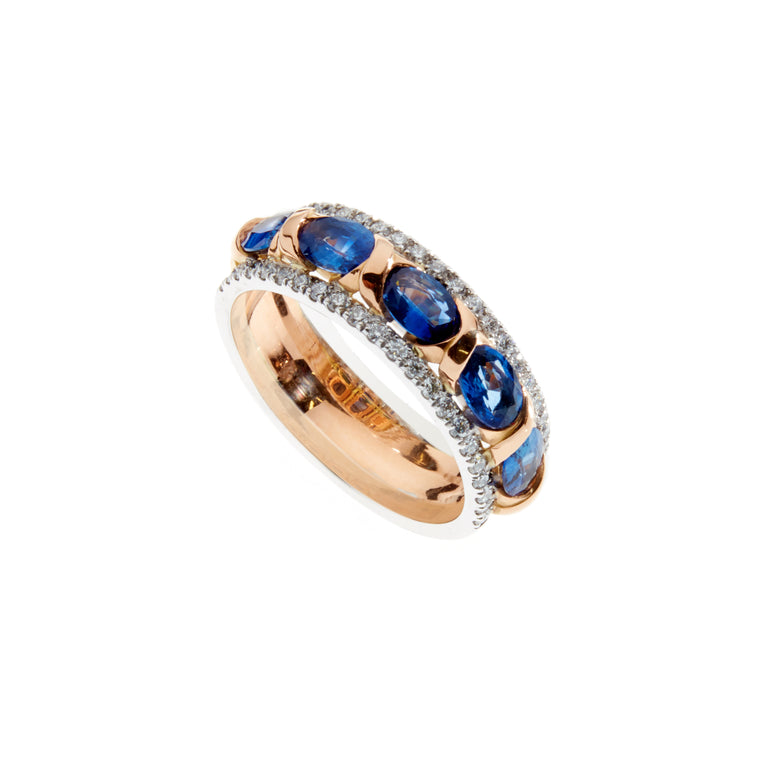 18ct white and rose gold ring. Set with five oval blue sapphires and 0.52ct of pave set diamonds along each edge.