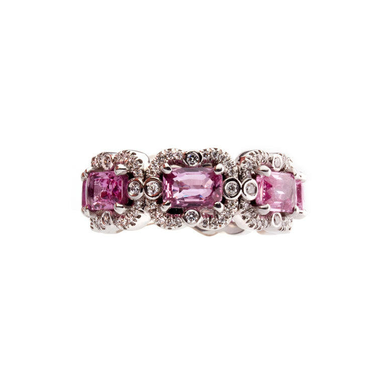 Emerald cut octagon pink sapphire eternity ring surrounded by round cut brilliant diamonds. Part of the Ballerina collection. 