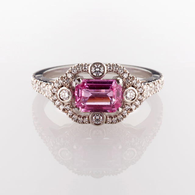 Emerald cut octagon pink sapphire surrounded by round cut brilliant diamonds. Part of the Ballerina collection. 
