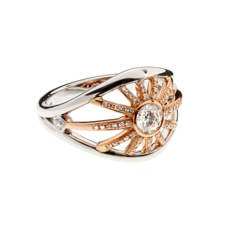 A diamond, white and rose gold ring with diamond studding spokes designed by Biagio Patalano for the Artistry collection.